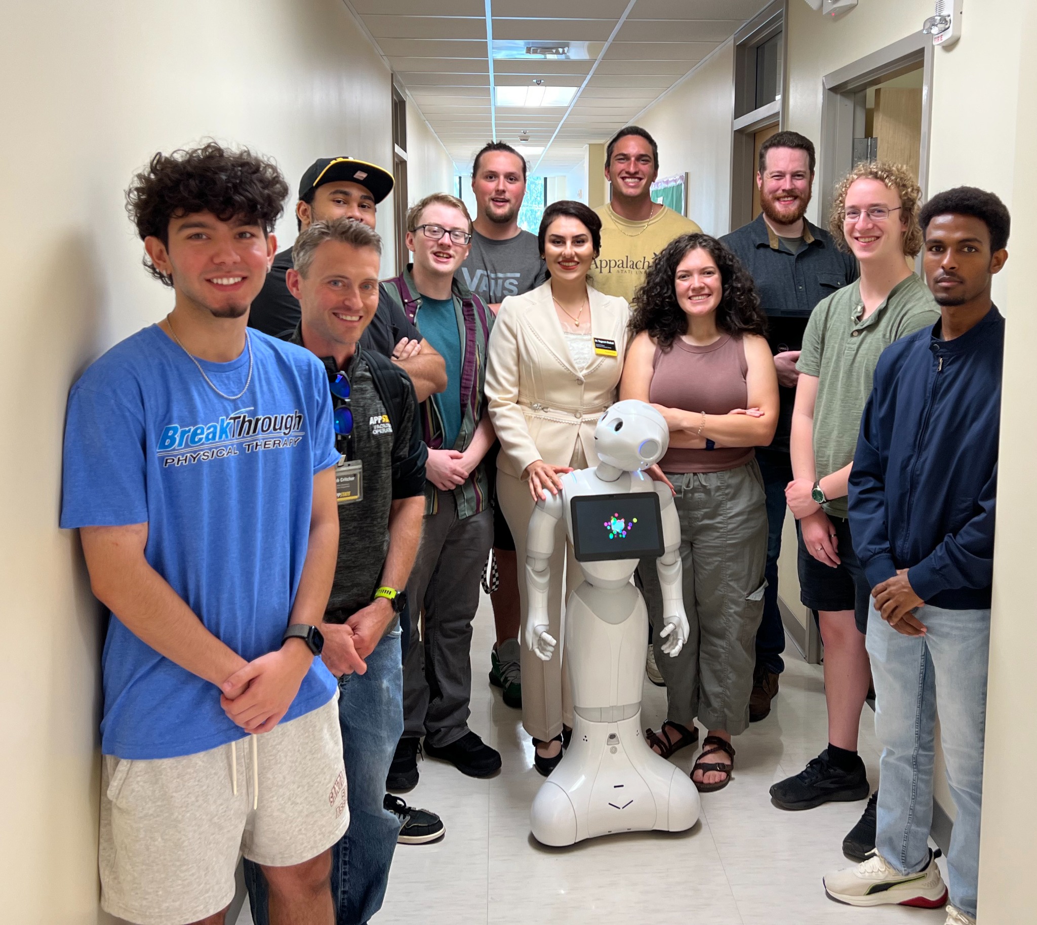 Team posing with YeRo humanoid robot